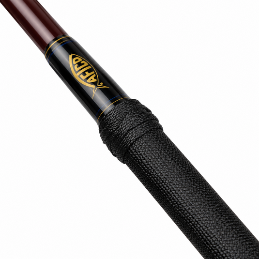 Close-up of AFTCO Fixed Gaff showing black textured grip and AFTCO logo