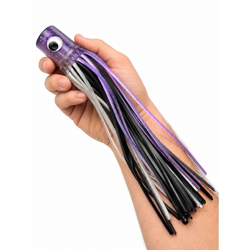 Load image into Gallery viewer, Mold Craft Senior Hooker 10-inch Purple/Black/Silver trolling lure held in hand for size reference, featuring a purple glitter head with reflective eye and purple, black, and silver skirt on a white background.
