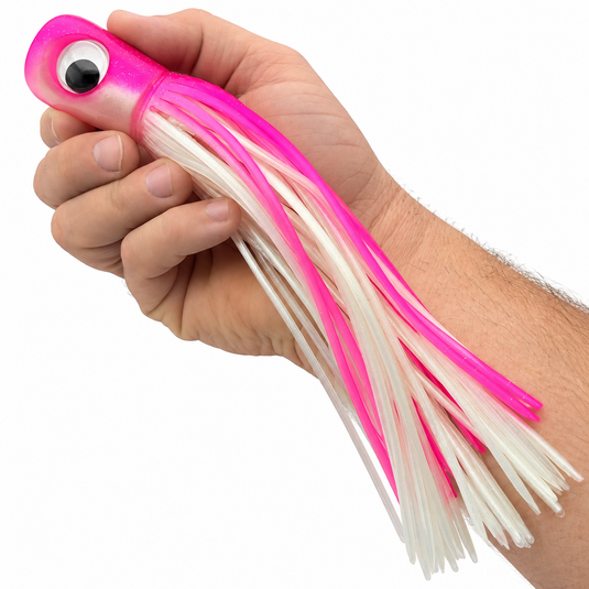 Mold Craft Standard Super Chugger 8¼ inch Pink/White offshore trolling lure shown in hand for size reference, featuring a pink glitter head and pink-and-white skirt.